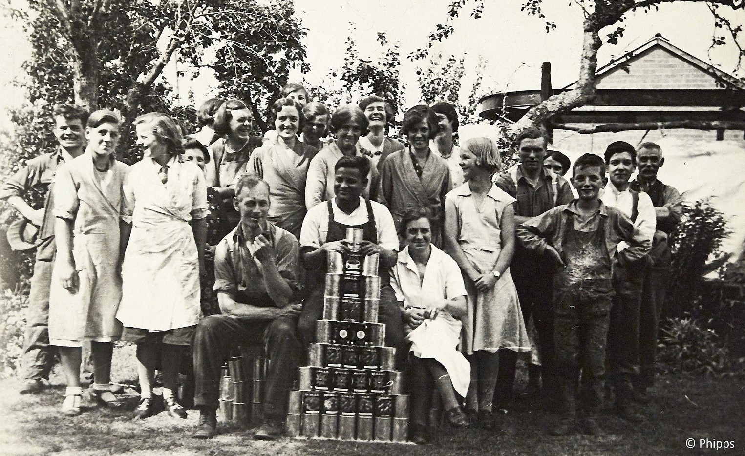 Group of workers with display of canned goods - informal, relaxed shot