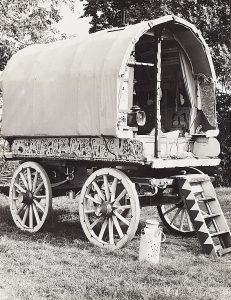 Black and white photograph of the exterior of an old-style caravan.