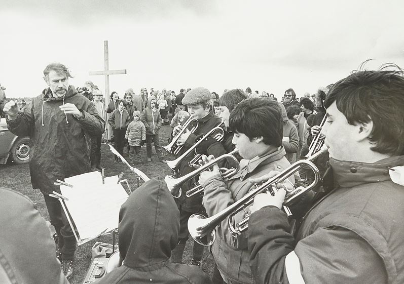 Young musicians playing outside whilst crowd watches