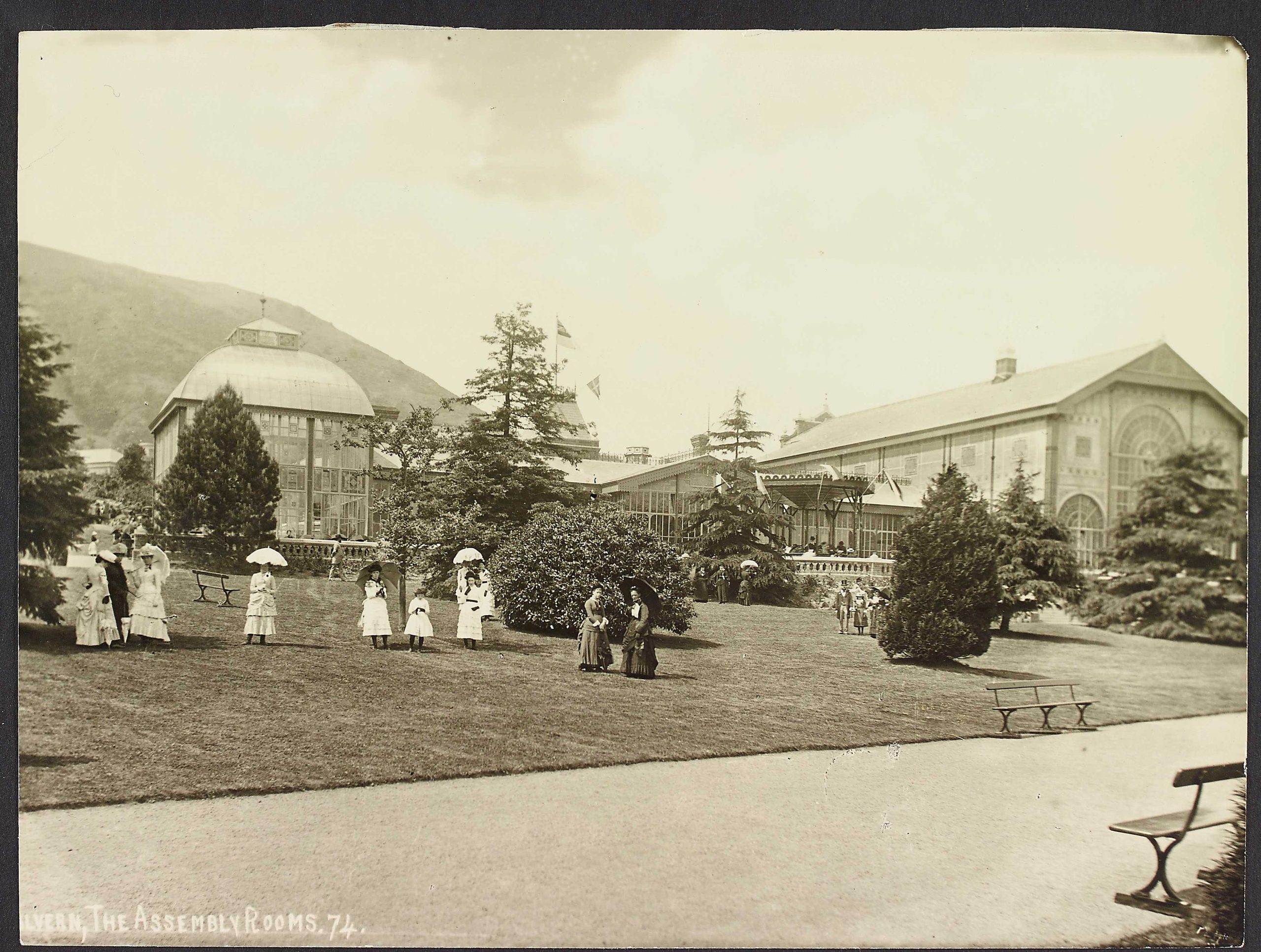 Ladies dressed in Edwardian dress with Parasols standing on the grounds outside the Assembly Rooms, Malvern