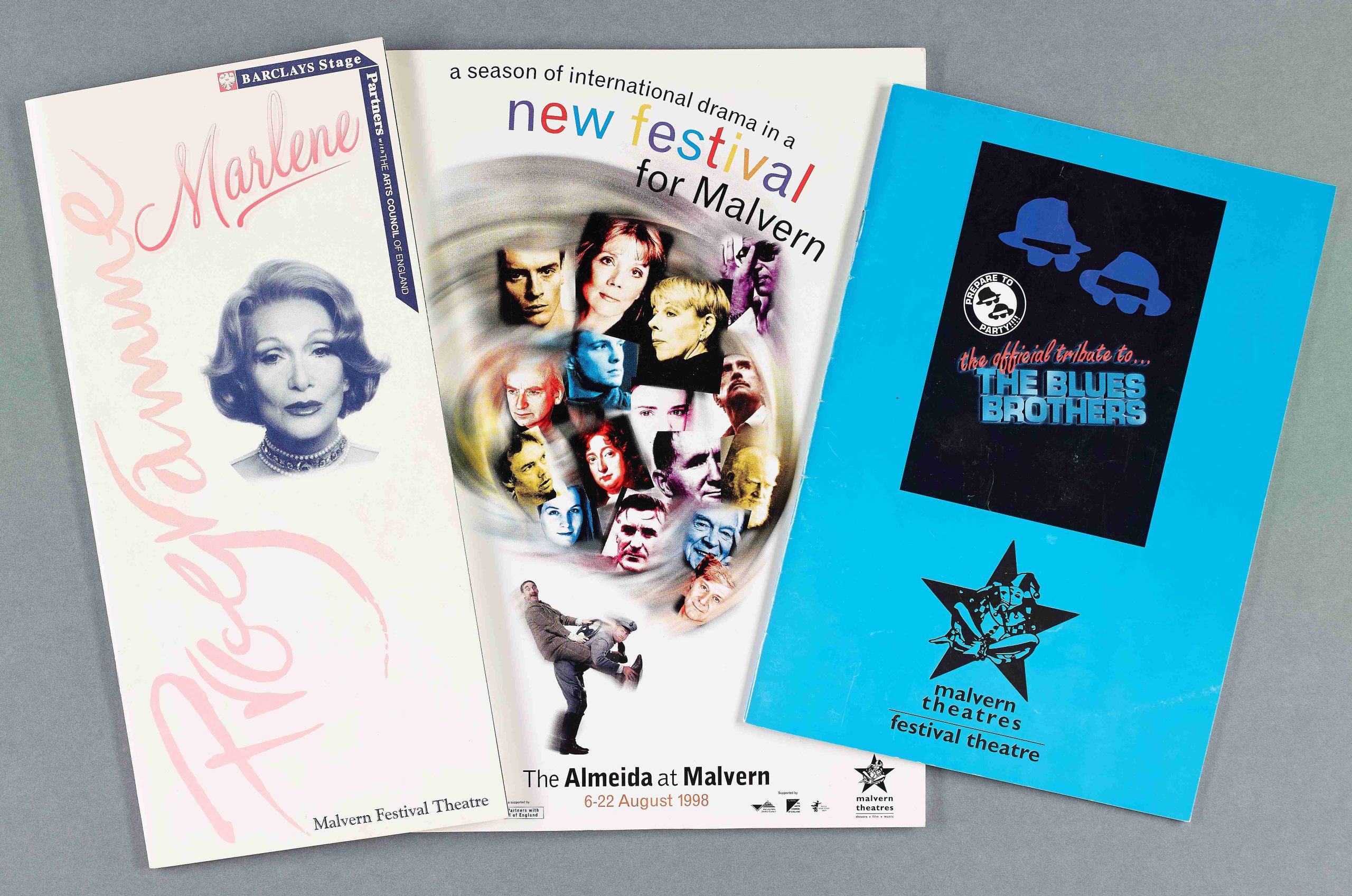 Photogragh of paper Theatre Programmes of Marlene, The Almeida Theatre Company and Blues Brothers performed at Malvern Festival Theatre and Malvern Theatres dated to the 1990’s 